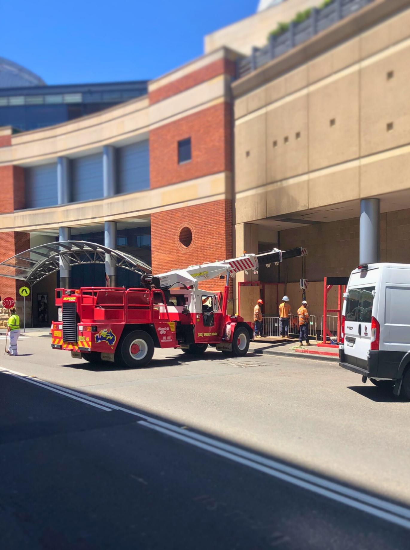 A Franna crane is used to lower loads down through the street level hatch