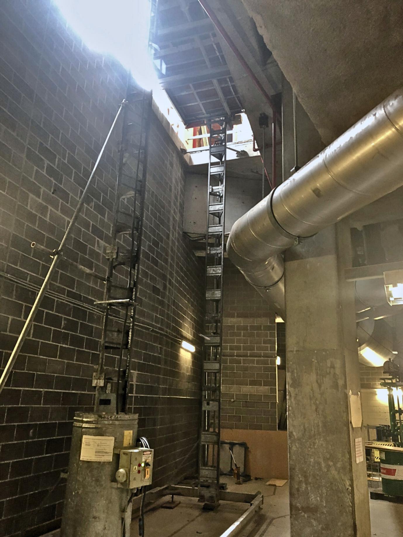 Material hoists are used to lower loads down vertical tracks