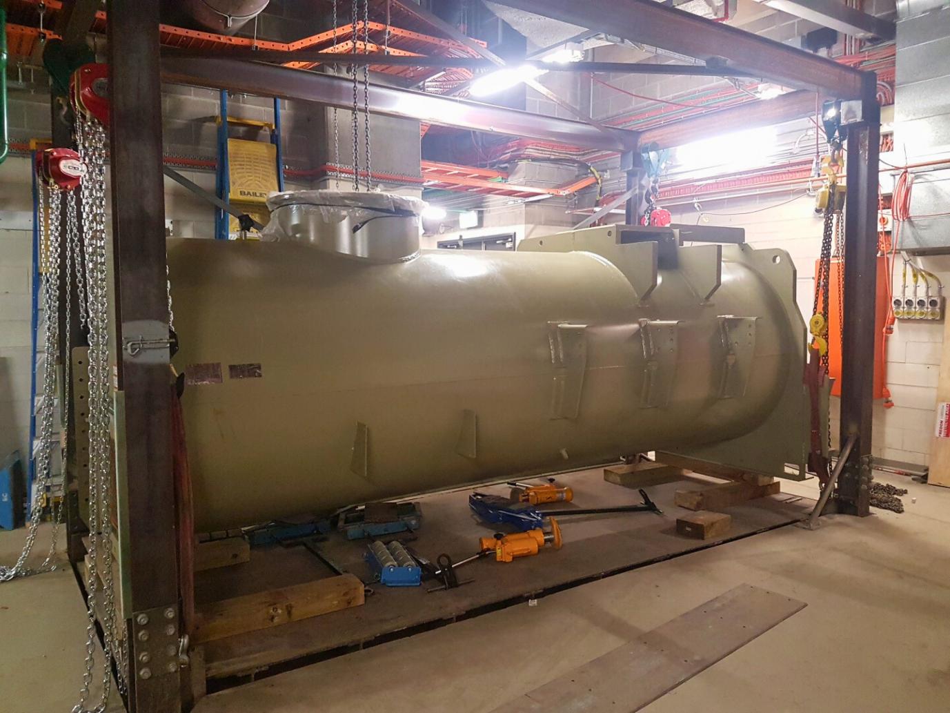 The chiller is rigged to be lowered by the fabricated steel custom hoist