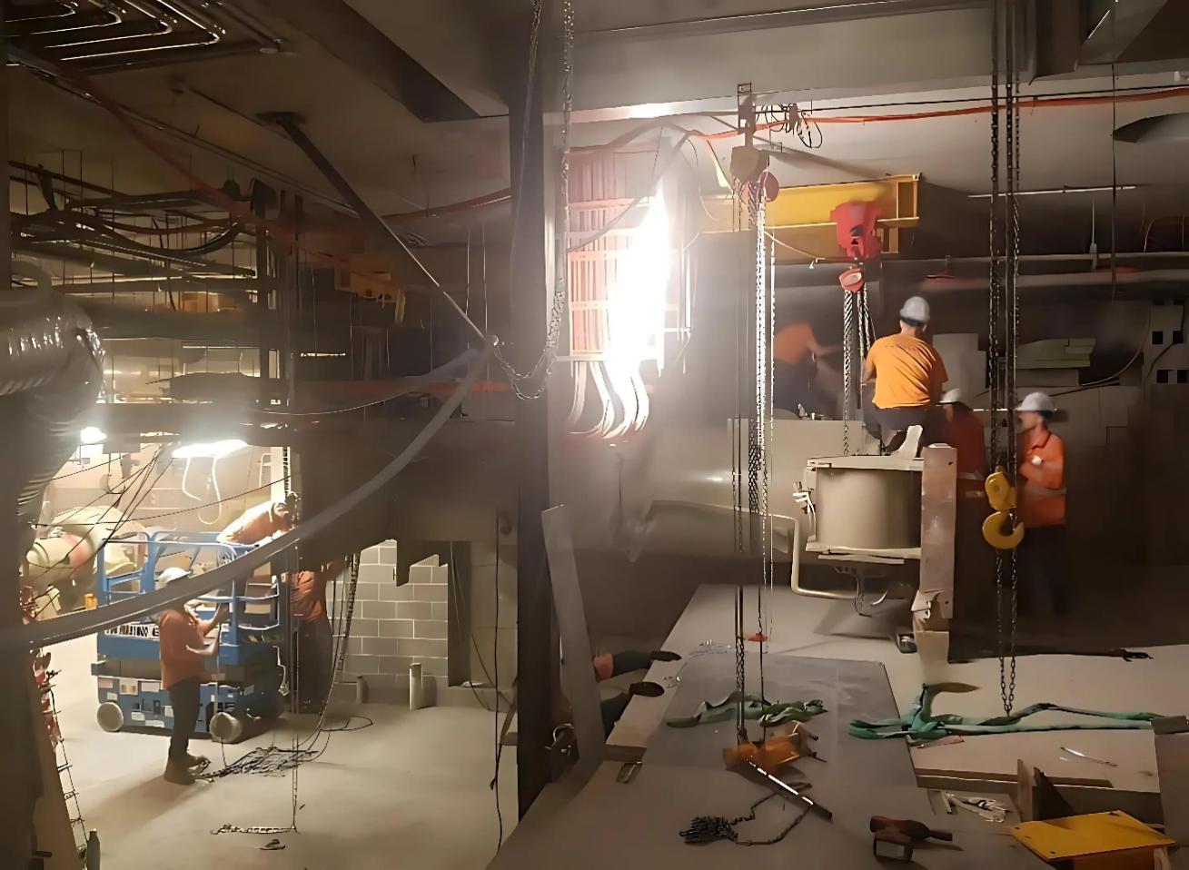 The chiller is slowly moved from the mezzanine to the B4 floor