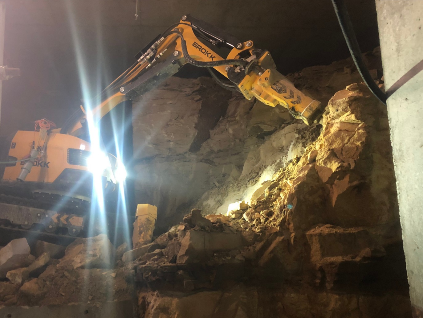 The brokk hammer being used to excavate sandstone and expand the size of the plantroom